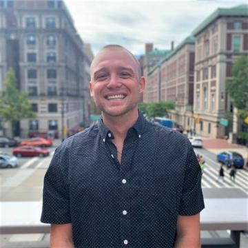 Anthony Hascheff with buildings in background