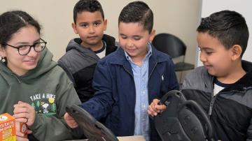 Rocio Garcia 26 with students in the iPad Program