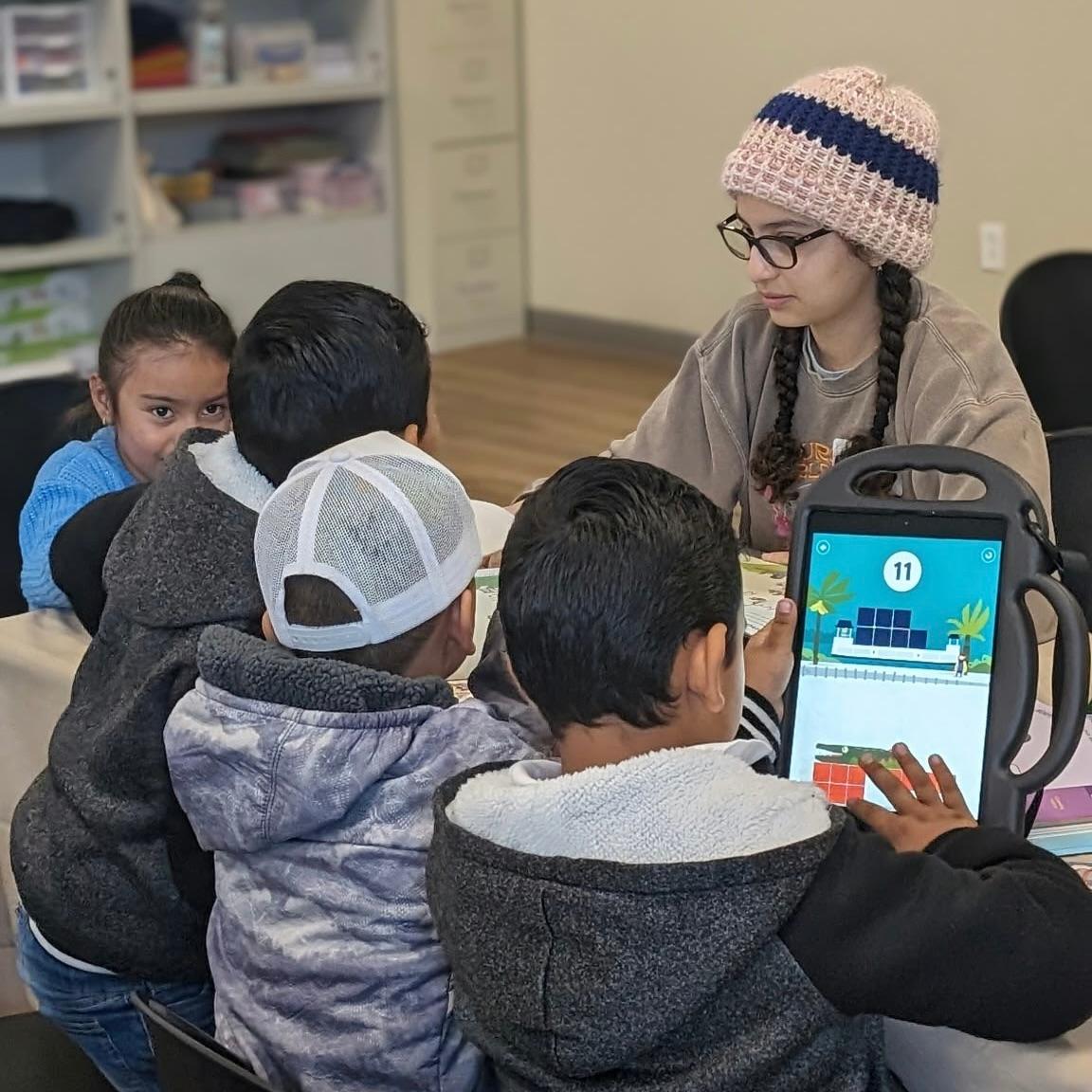 Rocio Garcia 26 with students in the iPad program