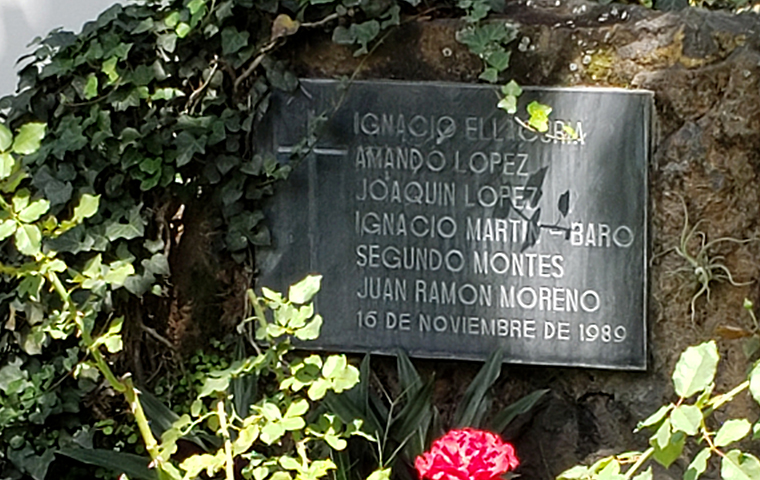 A plaque in the rose garden lists the names of all six Jesuit martyrs.