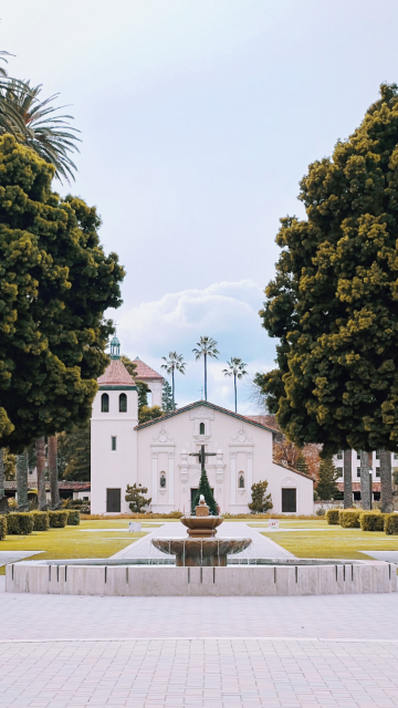 Title: Phone Wallpaper Fountain
Alt text: Fountain with a building and trees in the background.
