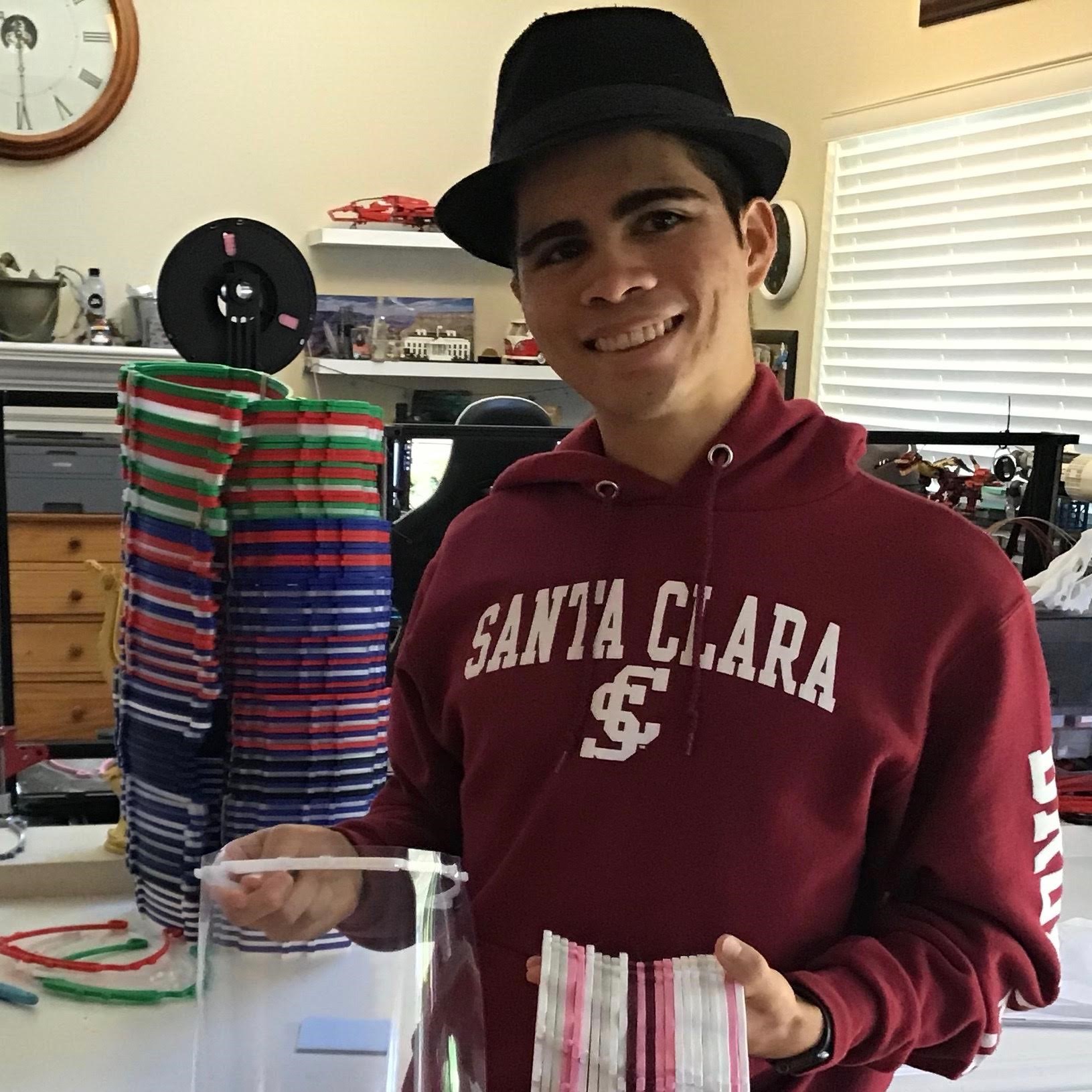 Person in a Santa Clara hoodie holding a drink in an office space. 