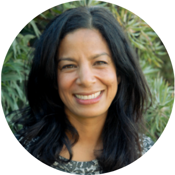 Dr. Estrella Ramirez smiling in an outdoor setting.