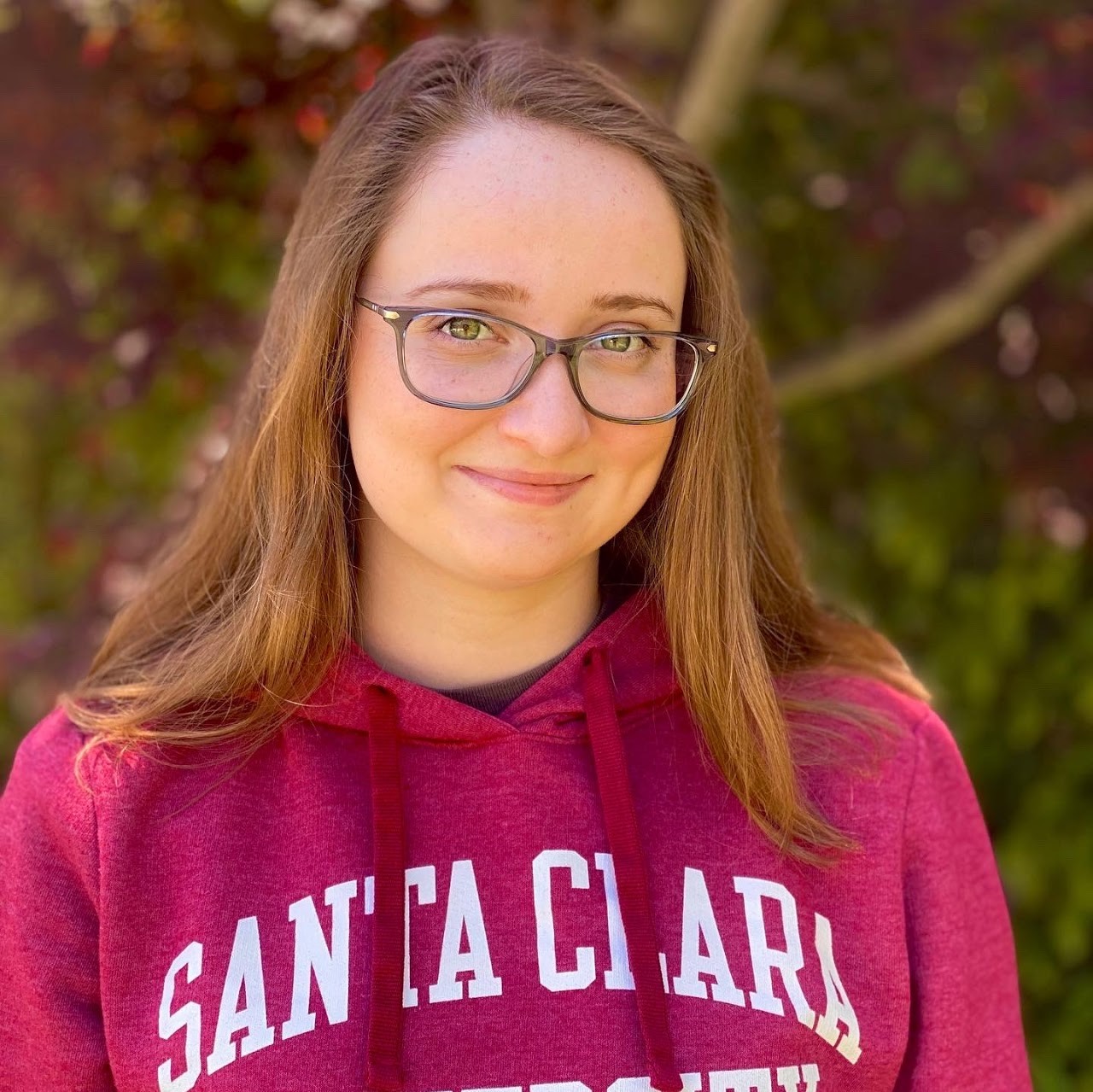 Person wearing glasses and a red 