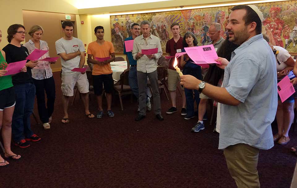 A group of people participating in a Havdallah ceremony.