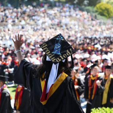Student walking across the stage at the Commencement ceremony