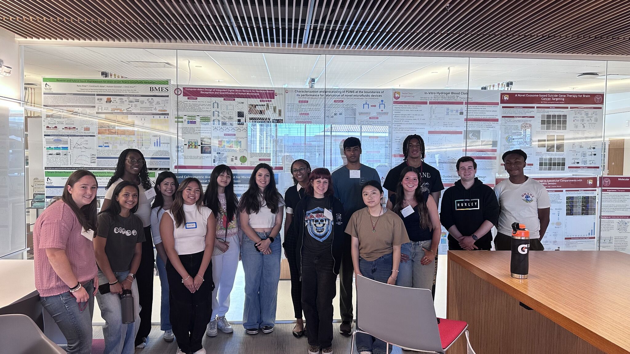 Group of students standing in front of science posters