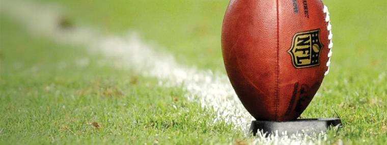 American football on tee, ready for kickoff at Super Bowl 50. image link to story