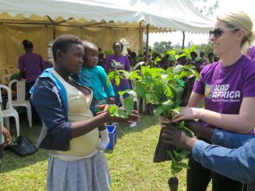 Woman with daughter accepting plant