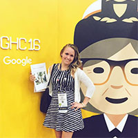 A person standing in front of a bright character backdrop.