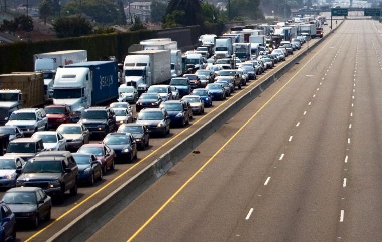 Heavy traffic congestion on a multi-lane highway, vehicles are at a standstill. image link to story
