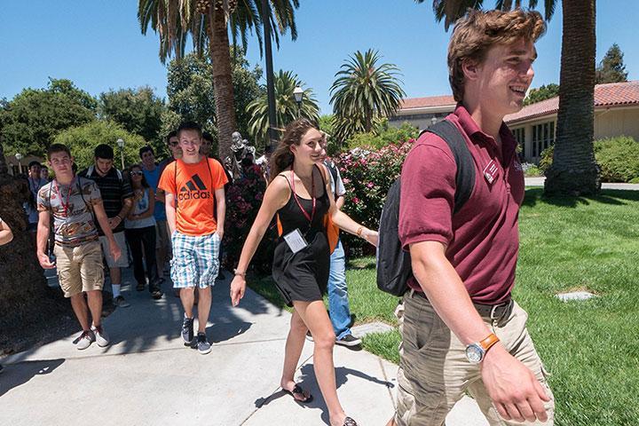 Students walking outdoors on a sunny day during orientation. image link to story