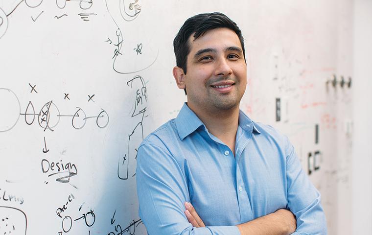 Photo of 2009 alumnus Jason Buenrostro in front of a whiteboard image link to story