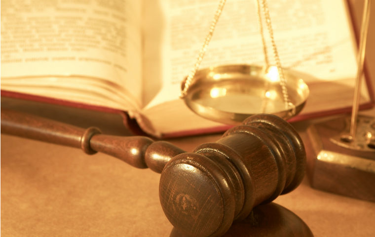 Image of gavel in front of scale and book image link to story