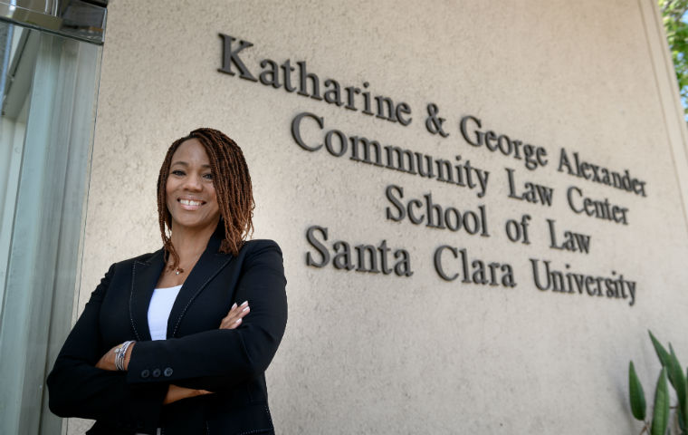 ED Deborah Moss West in front of SCU Laws Alexander Law Center image link to story