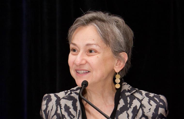 Woman speaking into a microphone at Foscarinis AlexPrize 2016 ceremony. image link to story