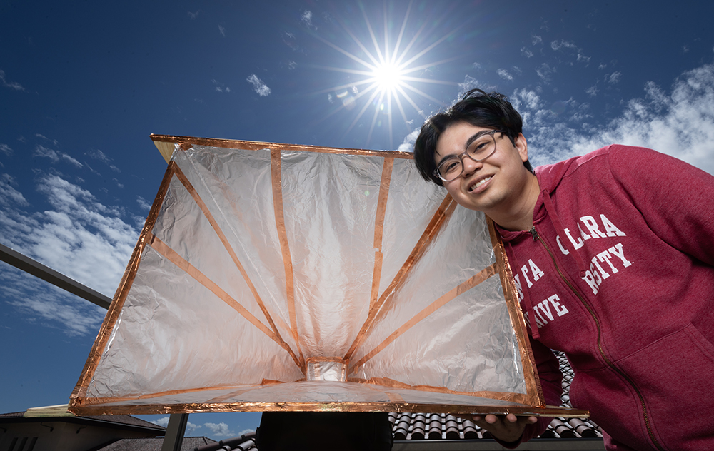 Tyler Ikehara ’22 and his Radio Telescope on the roof of SCDI. Photo by Jim Gensheimer