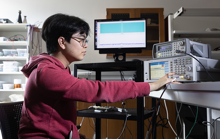 Tyler Ikehara reads findings of his Radio Telescope on a computer screen.