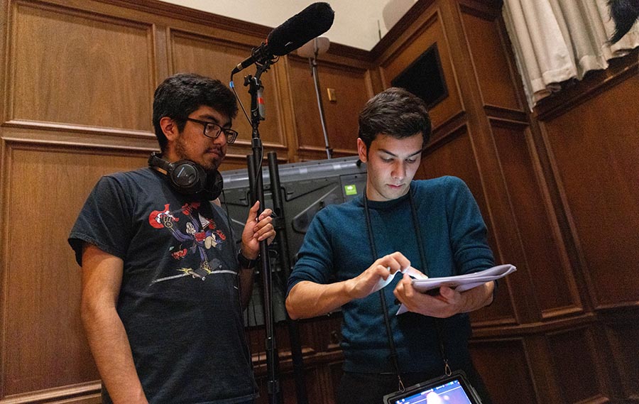 Two men work on movie set.