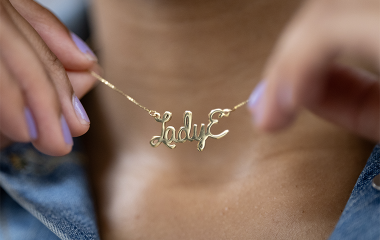 Close-up photo of Lady Elizabeth Roy '24 holding her 'Lady E' necklace.