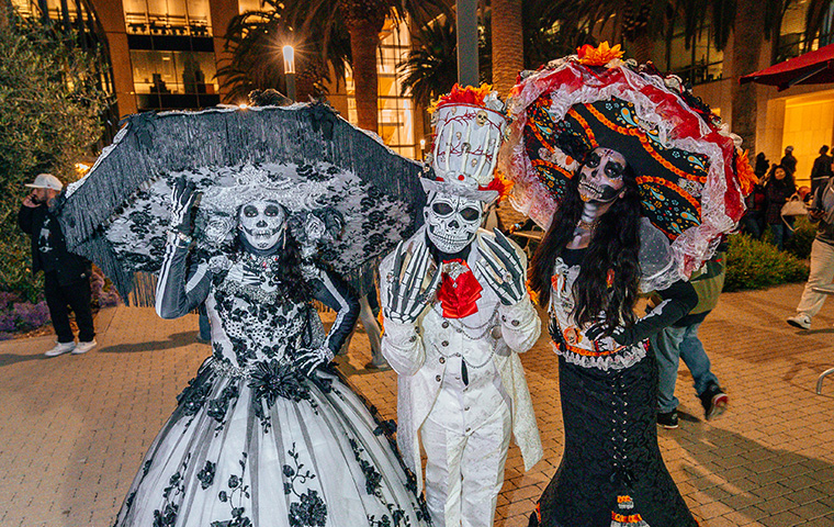 Three Camino de Los Muertos celebrants in dressed up skeleton costumes