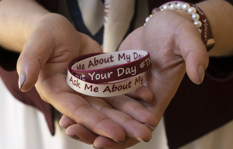 Hooria Jazaieri holds a pair of 'Tell Me, Ask Me' wristbands.