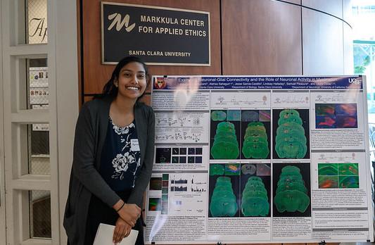 Alekhya Parvathaneni ’20 and her SCU keepsake poster from the Laura Cocas lab.