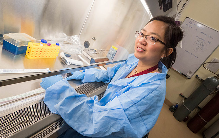 Mai Anh Do conducts research under a hood in the Bannan Engineering Labs
