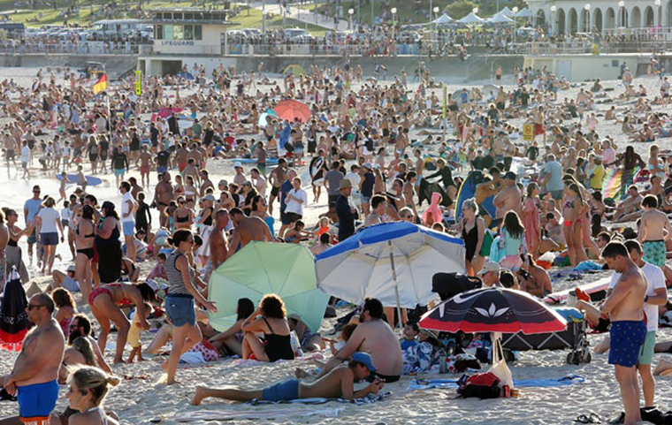 Groups of people on a beach image link to story