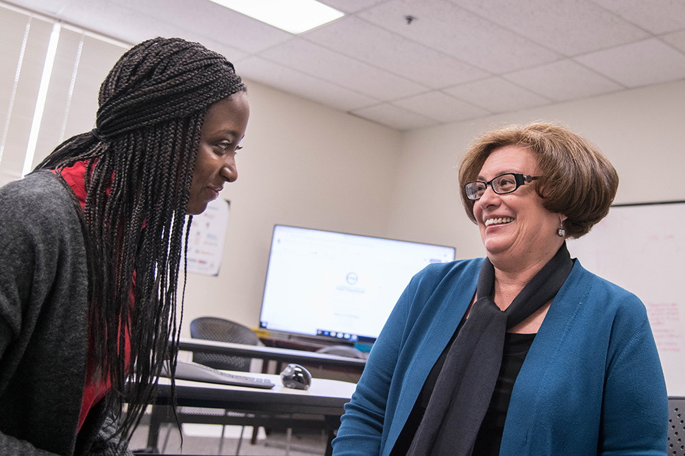 Public health and biology major Kayla Williams, left, works with her CEO mentor Dolores Alvarado, at Community Health Partnership. Photo by Charles Barry.