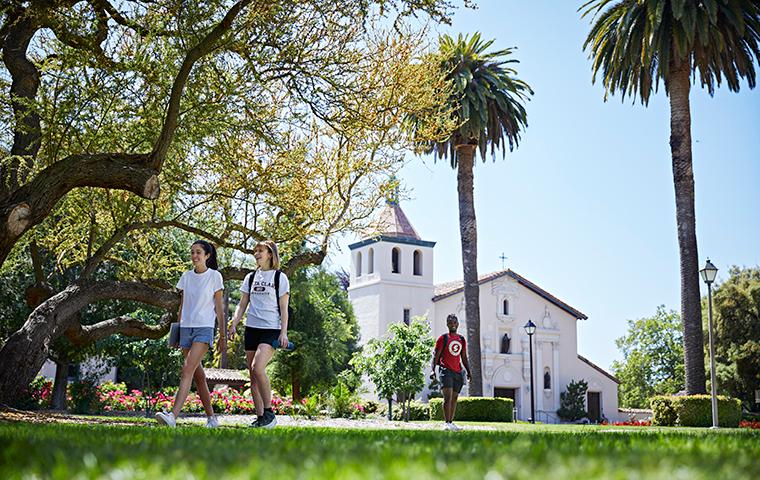 Students walking on path with Mission Church in background