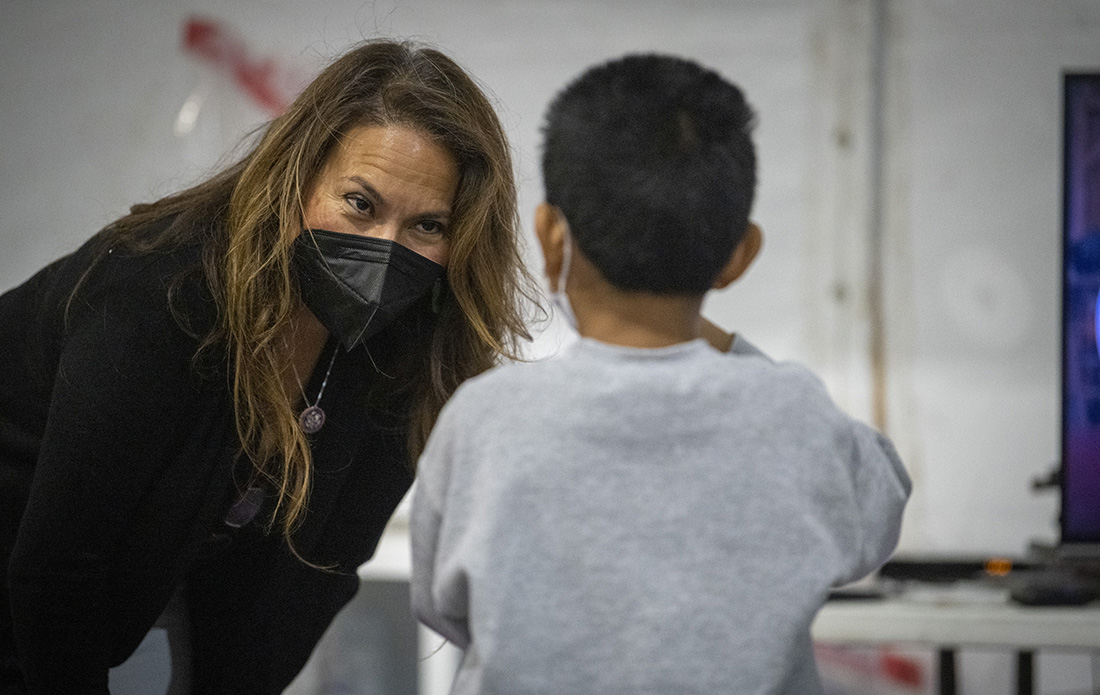 Veronica Escobar meets with a migrant child at the CBP processing center