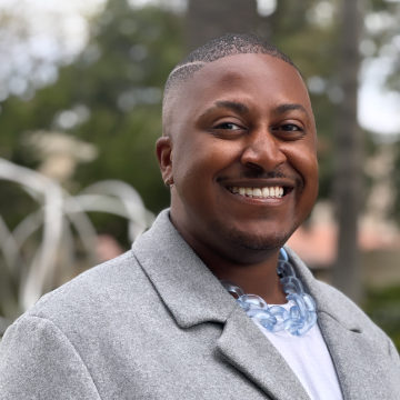 Marqus Koranteng in gray sweater