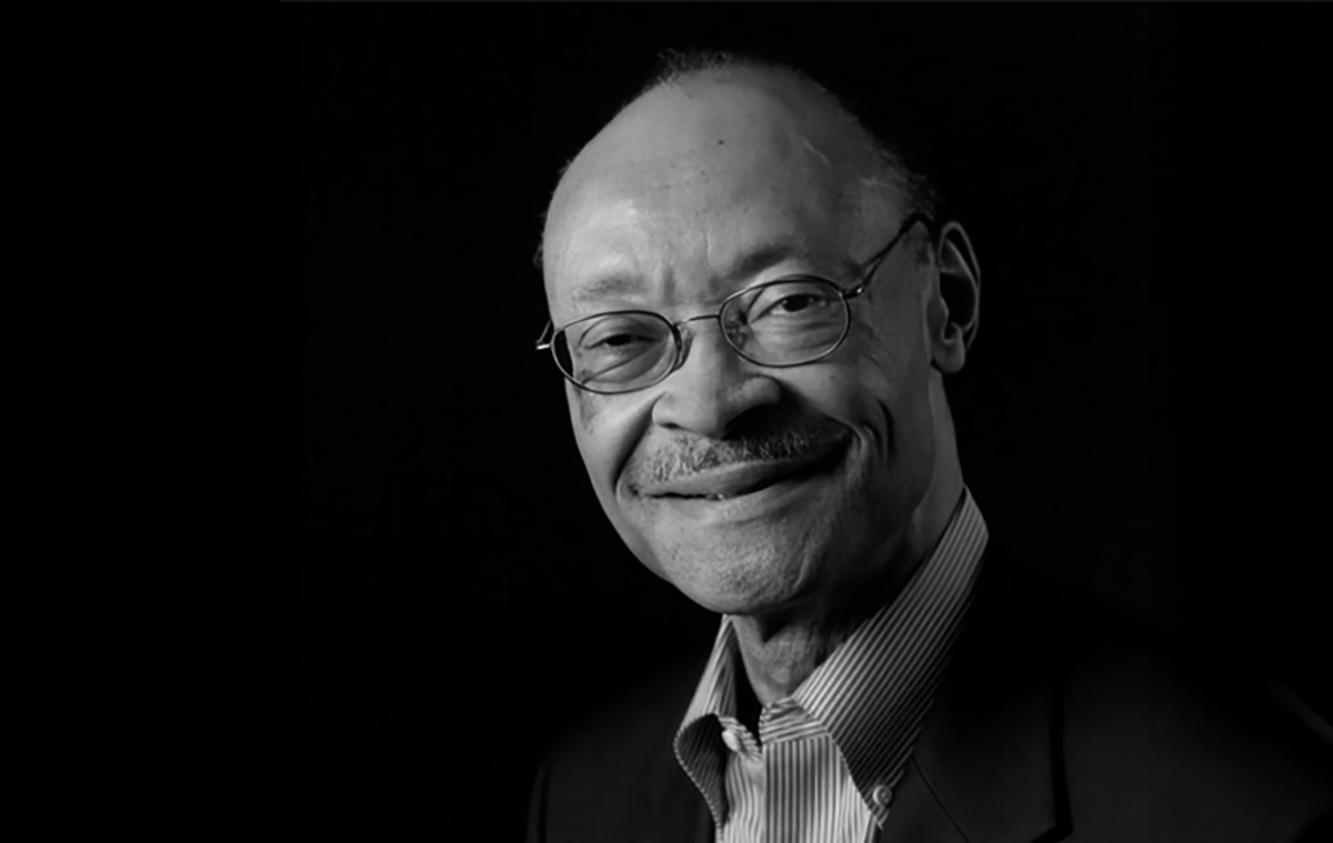 Black and white photo of Frank Greene Jr on black backdrop