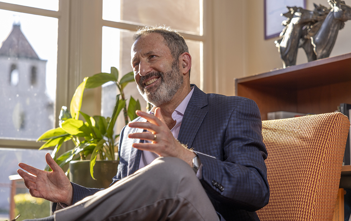 James Glaser sitting by a window, smiling
