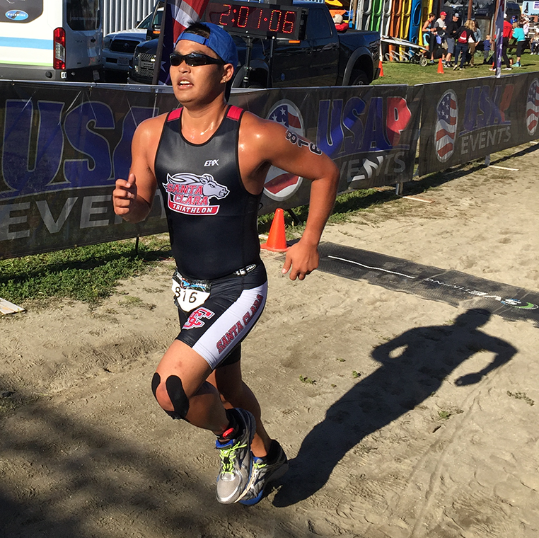 A man, Jared Shimada, racing along a dirt path.