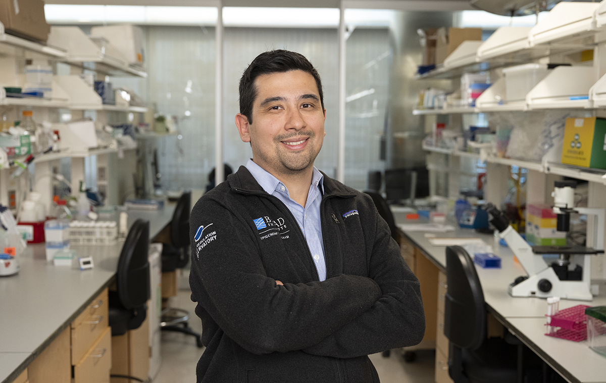 Jason Buenrostro stands arms crossed in his lab