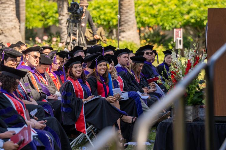 Seated students in gowns at SCU Law Commencement 2022