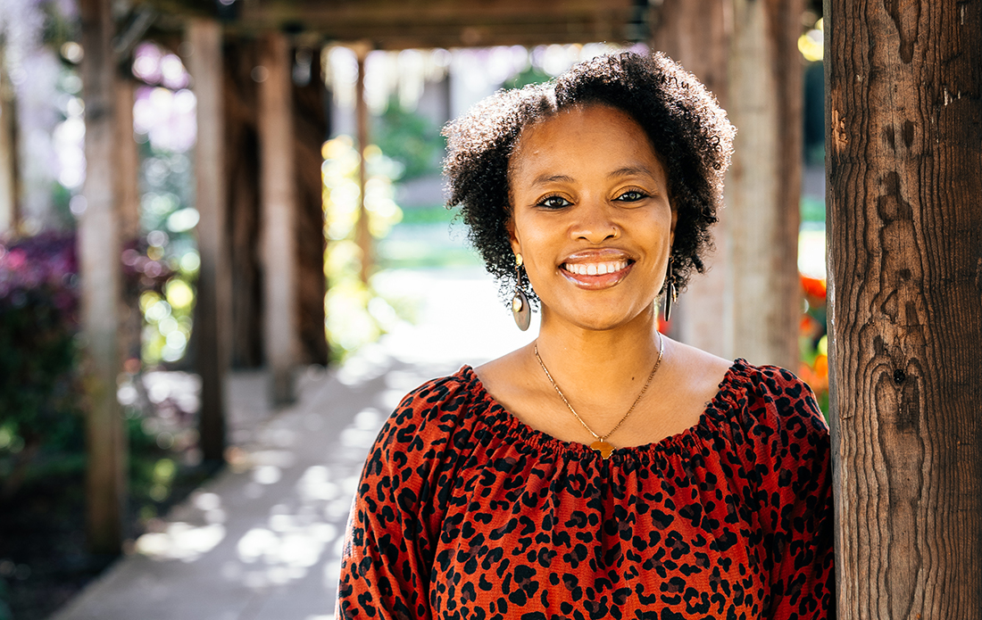 Kai Harris standing in walkway next to Mission under wisteria