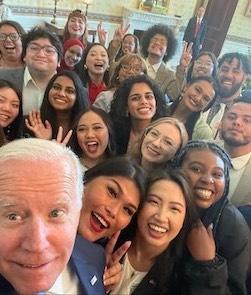 President Joe Biden takes a selfie with youth participants at the Mental Health Youth Action Forum.