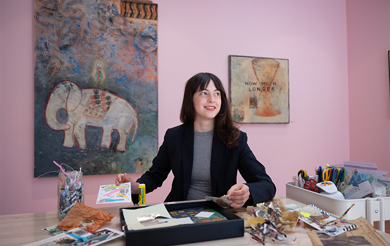 Katherine DeRitis '24 organizes a table of do-it-yourself art materials for visitors at the Inez Storer art exhibit.