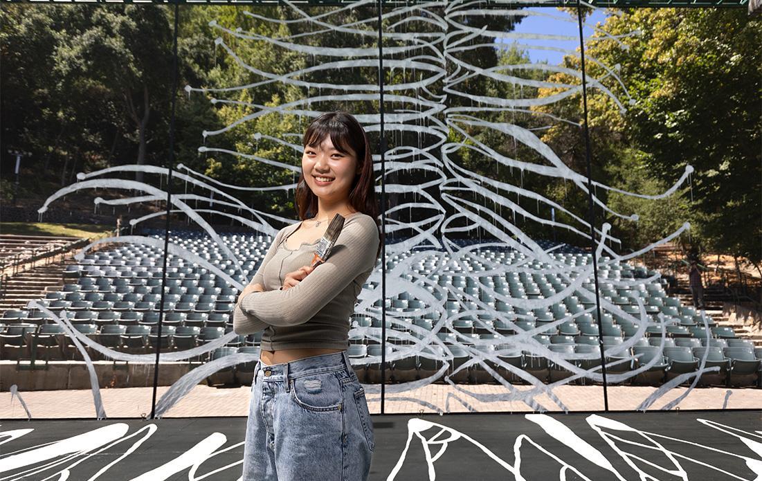 Lydia Kim '24 surrounded by the interactive artwork she helped artist Carole Kim create this summer.