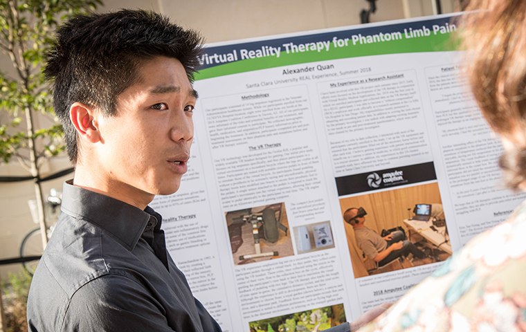 Student presents their summer research at a REAL Program symposium.