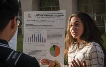 Student presents their summer research at a REAL Program symposium.