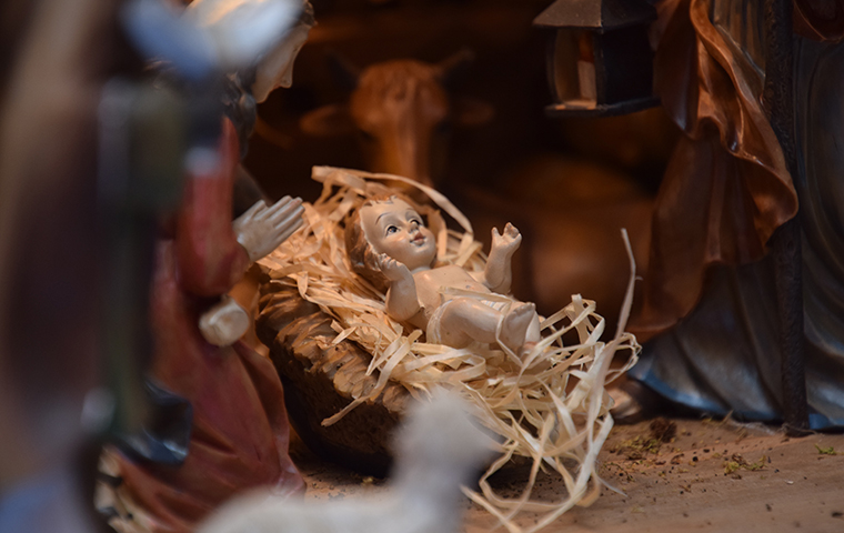 A figurine of baby Jesus in a nativity scene