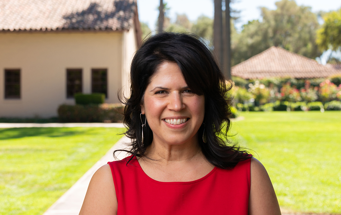 Anna Sampaio standing behind Mission Church