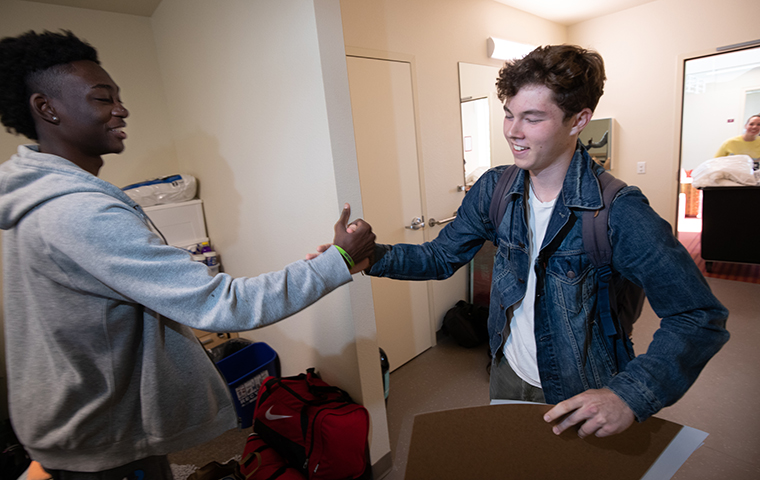 Two male roommates meet for the first time in their residence hall room