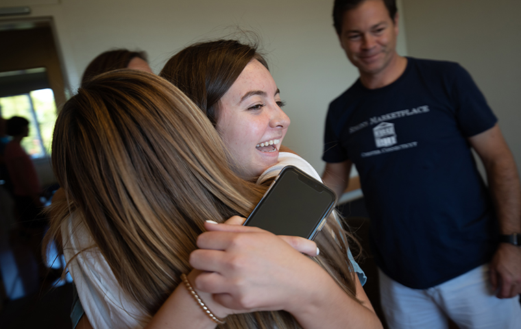 Student hugs new roommate for Welcome Weekend