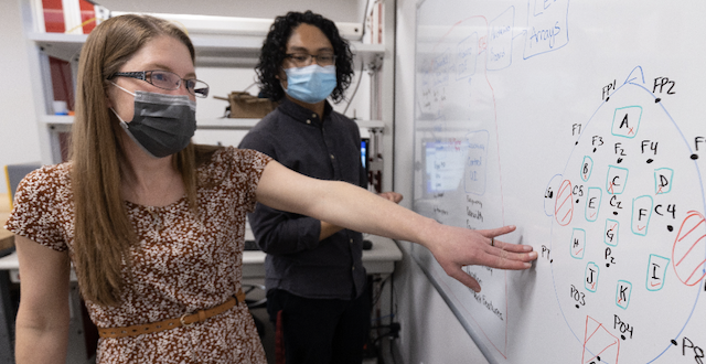 Julia Scott, senior research associate in SCU's Bioinnovation and Design Lab, discusses prototype calculations with electrical engineering major Michael Bose '22.