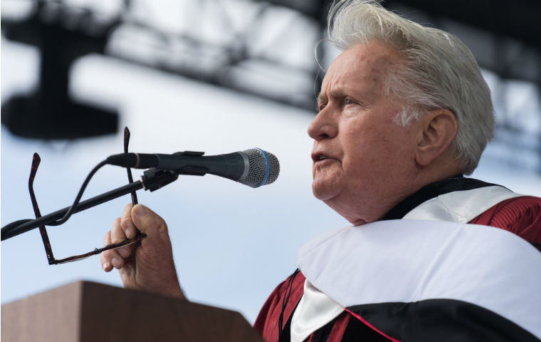 Martin Sheen speaking at 2019 commencement image link to story